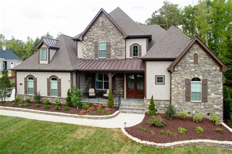 painted brick house with brown metal roof|brown brick house exterior.